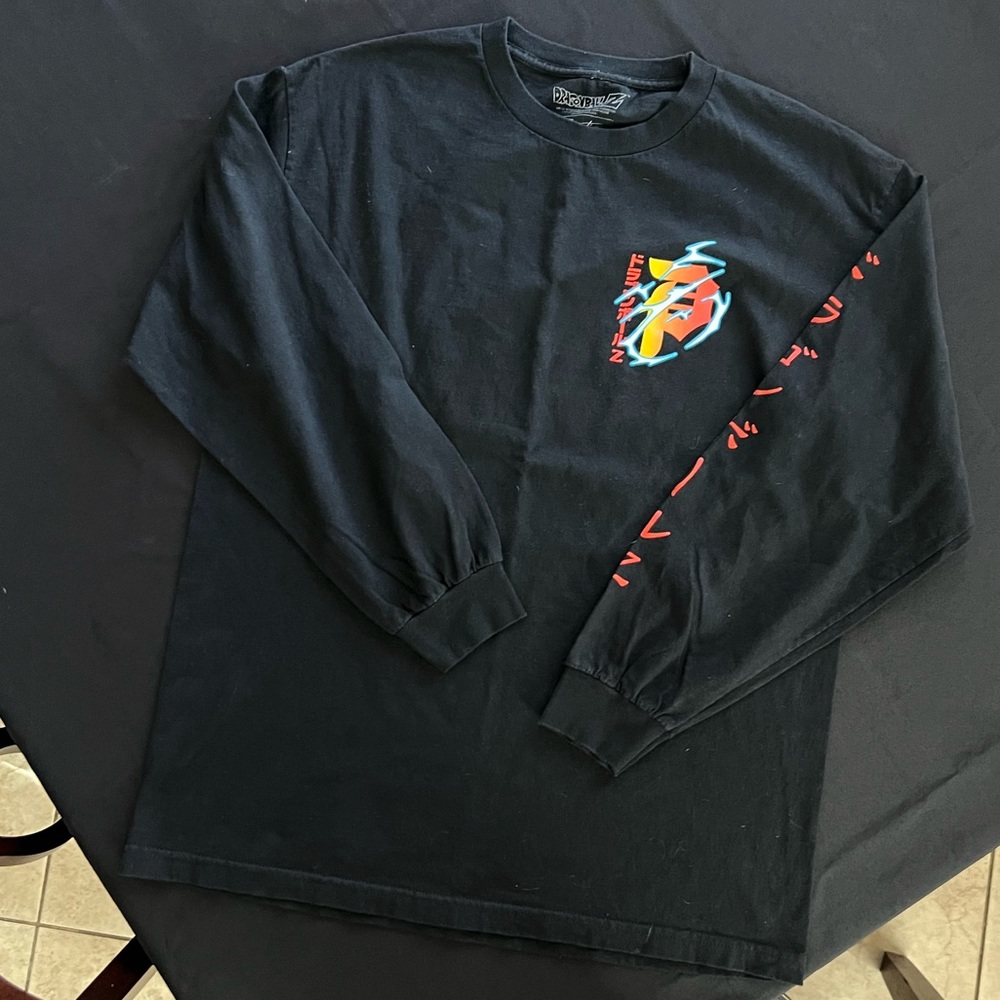 Black and multicolored Primitive long sleeve with design on shirt, size large .